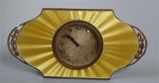 An Art Deco silver and yellow guilloche enamel desk clock with silvered Arabic dial in pierced cartouche mount, Birmingham 1930,